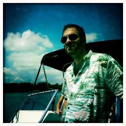 Magazine and website editor and writer, dad, known for wearing Hawaiian shirt on a boat.