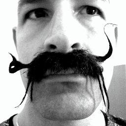3x Freestyle Moustache World Champ, 6x American facial hair Champ, vegan, model, chess coach, DJ, drummer, poet, traveler, Renaissance Man of 1000 faces.