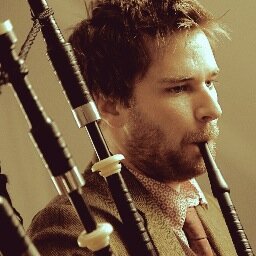 I'm the Highland Piper, Uilleann Piper and Whistle Player for the band Gaelic Storm. I also teach online bagpipe lessons and live in Chicago.