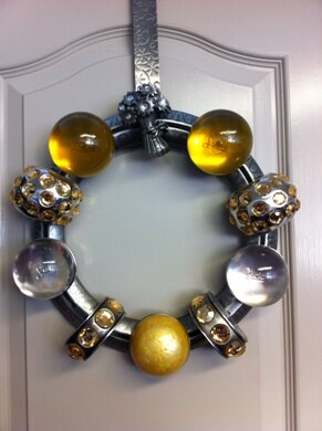 One of a kind hand crafted wreath. Like a giant charm bracelet for your home!