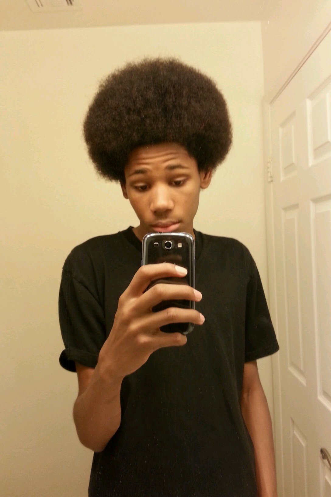 That nigga with a pick in his fro and a blunt in his mouth