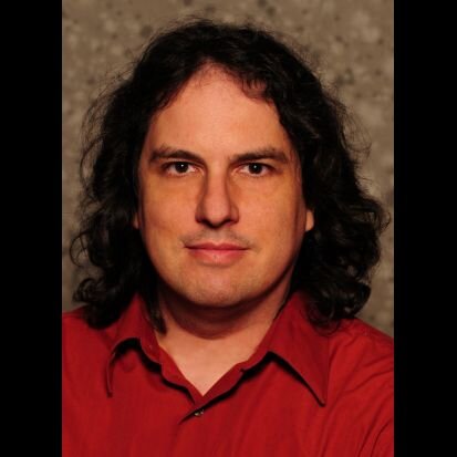 Enjoys live music, performing in Gilbert and Sullivan shows, singing, and trying to create electo-mechanical gizmos in his basement.