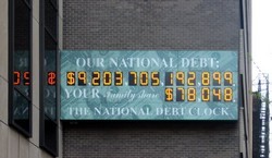 he National Debt Clock is a billboard-sized running total digital seven-segment display which constantly updates to show the current United States public debt