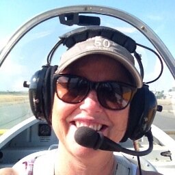 Works at Bella Luna Winery, Married to Sherman Smoot, enjoys flying vintage airplanes.