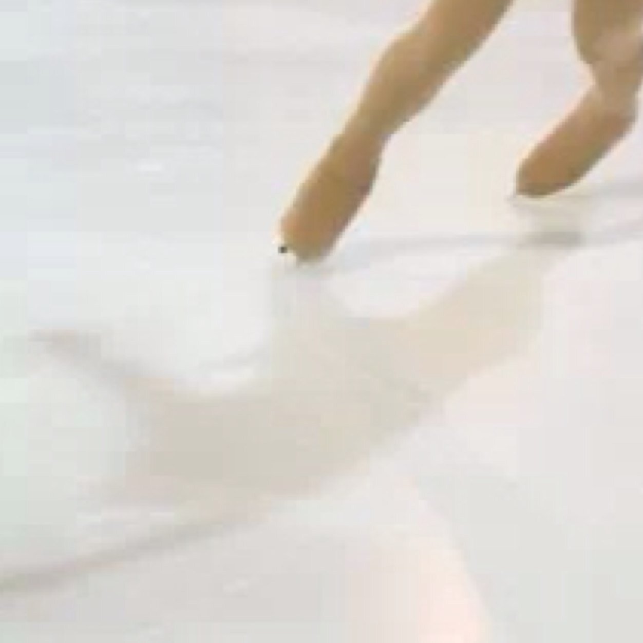 a figure skater trying to program a crazy life while watching hockey in the middle of a racetrack.