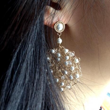 I wrap, coil, weave, knit and crochet gold and silver with gemstones and pearls into little pieces of magic to wear.