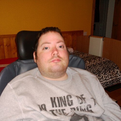 Brown hair Brown eyes and in a chair