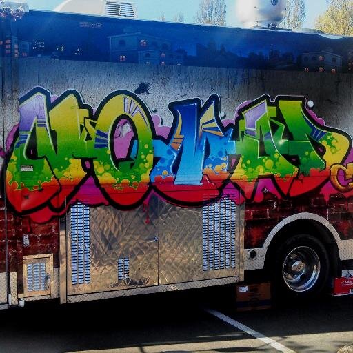 Inner city food truck wrapped in graffiti serving twisted comfort foods.
