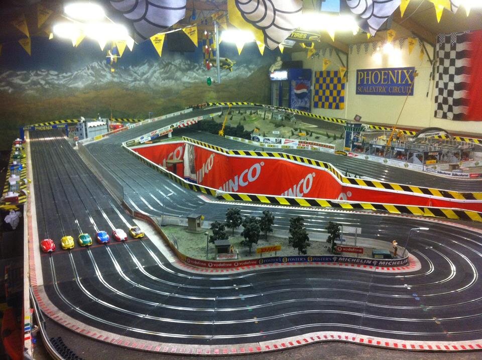 A 150 feet long 6 lane track with fully computerised race management and awesome scenic accessories. We offer friendly, fun & competitive Scalextric racing