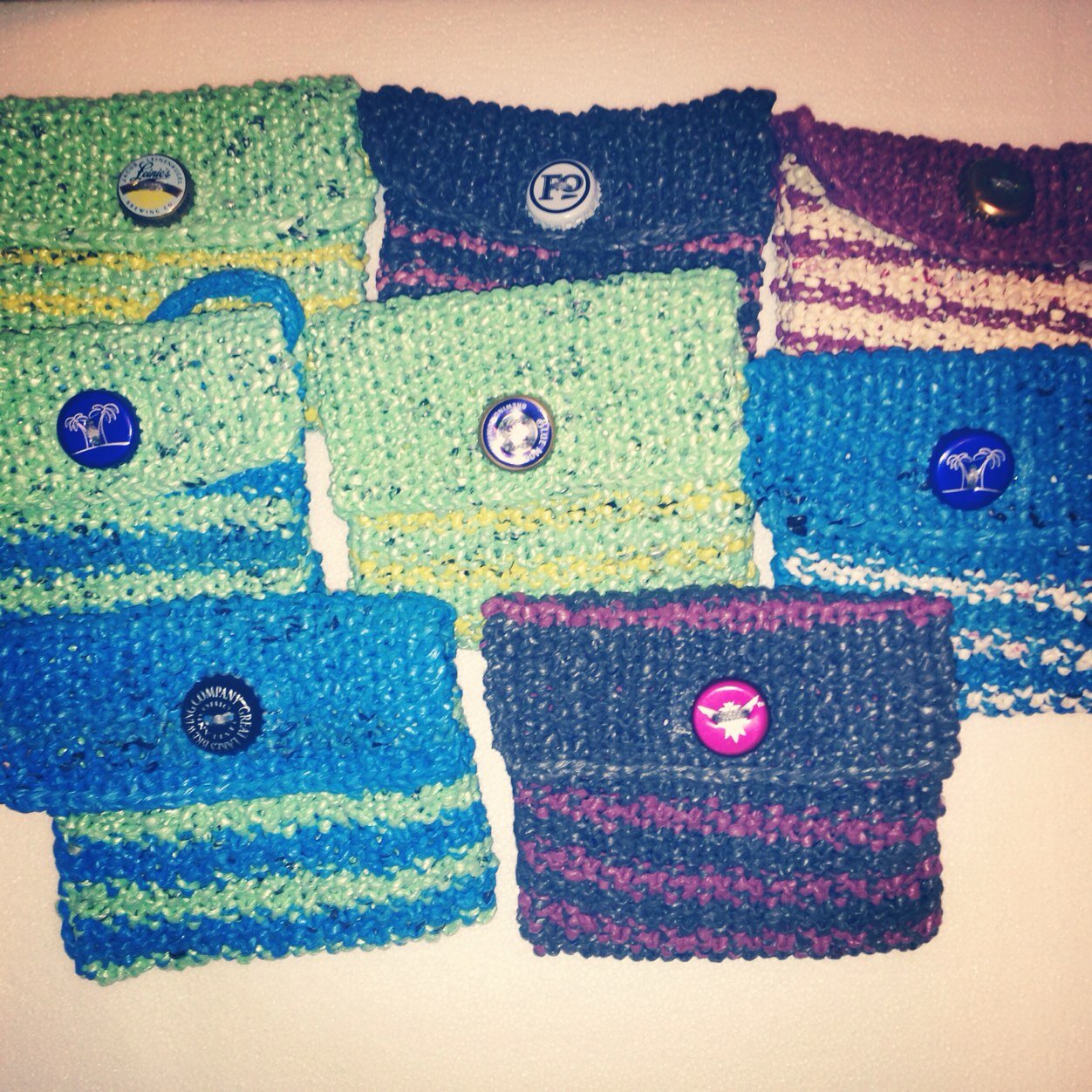Hand knit cross-body plarn purses.