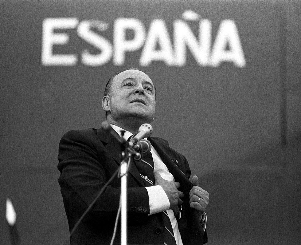 Notario y Doctor en Derecho. Fundador y Jefe Nacional de Fuerza Nueva, Consejero del Movimiento y Diputado por Madrid. Cuenta homenaje.