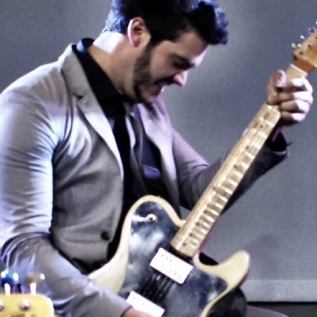 I make a living playing guitar and singing a little bit. Not too bad.