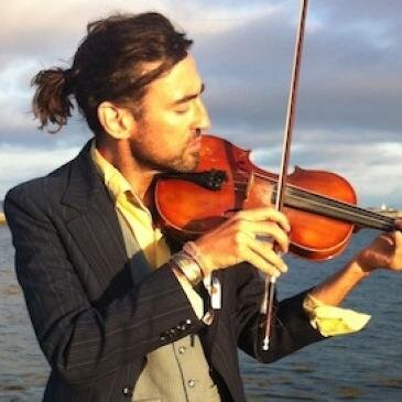 The_Latchikos's profile picture. Credited as the originators of “Gyp-Hop” (Gaelic gypsy hip-hop), blending together a raw mix of virtuoso violin, spoken word and raw, driving Gaelic beats.
