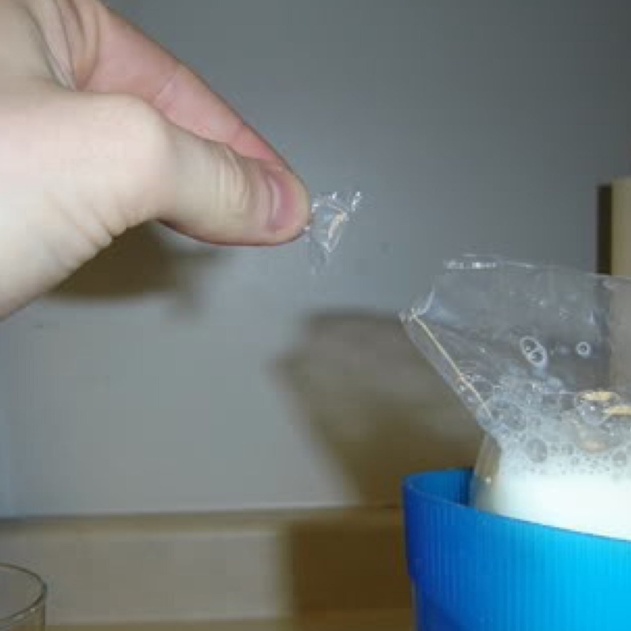 I am the cut off corner of a milk bag. I get thrown out and left behind. Without me no milk would be poured. I am the tuppy!
