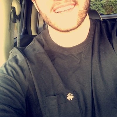 Southern Gentleman with a glass of sweet tea in one hand and the other on the steering wheel.