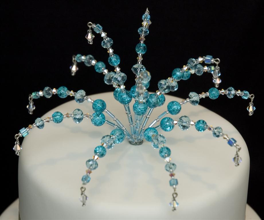 I handcraft beautiful swarovski crystal and beaded wedding cake toppers. Each one is individual. Check them out on...