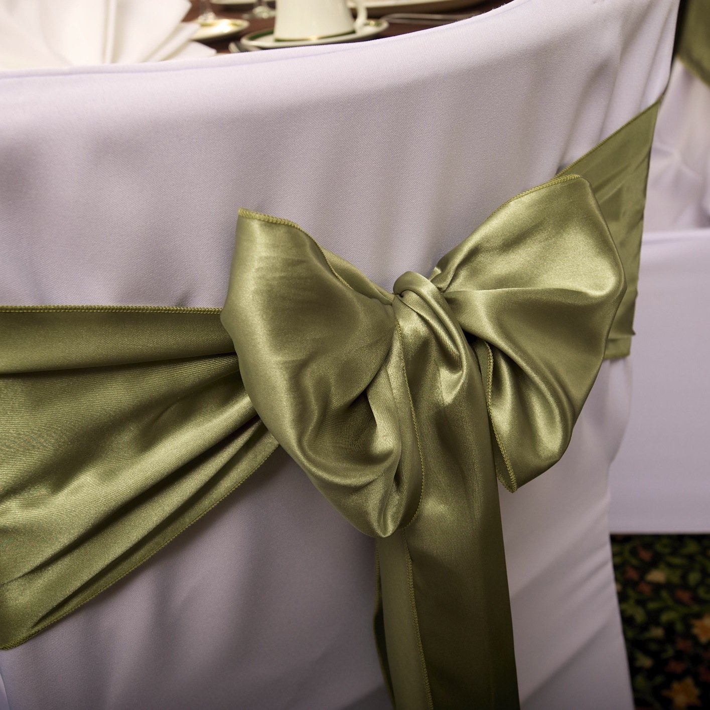Providing affordable linens including white, ivory and black chair covers, sashes, table overlays, runners, and more in a wide variety of colors and fabrics.