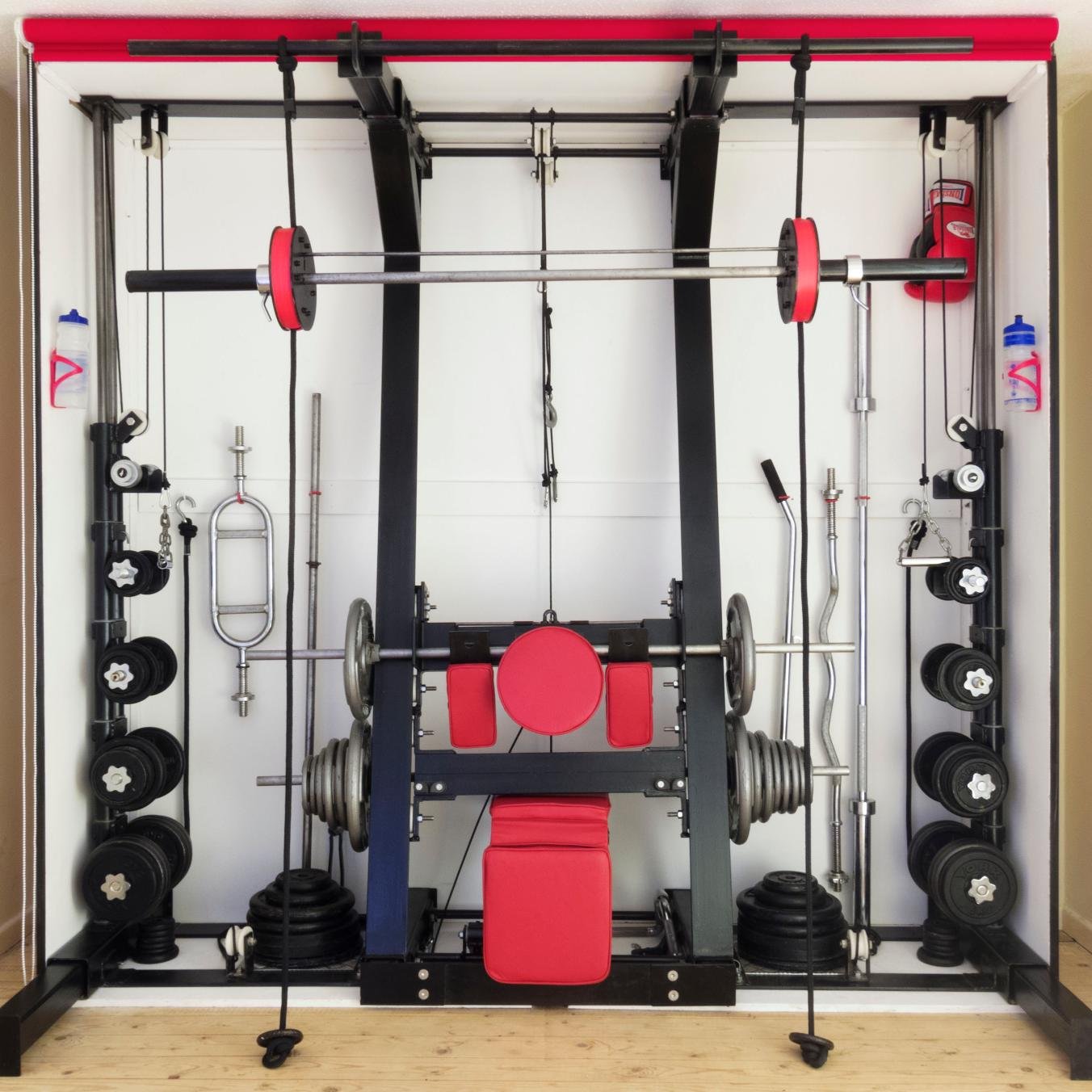 The IGym is a free weight multi-function strength and fitness machine which fits into a custom built cabinet less than 2 foot deep when closed