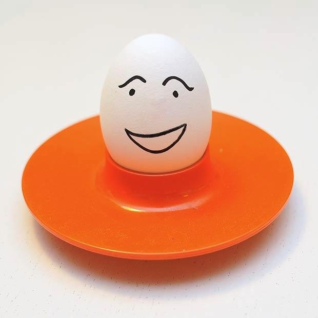 Egg on an orange saucer.