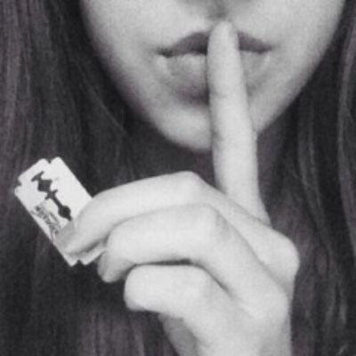 smile on her lips, scars on her wrist