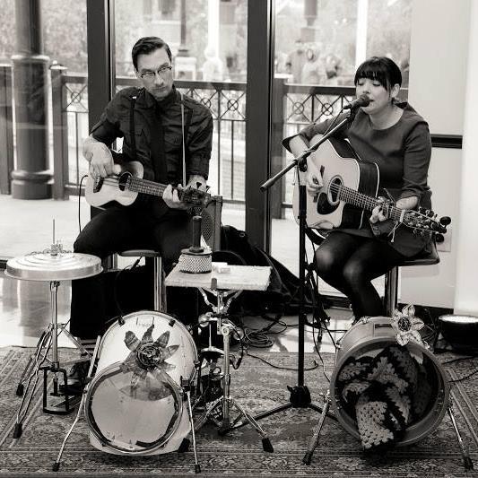 The 2 Left Shoes - Leah: Vocals/guitar + Daniel: Bass/vocals - 2 people, 2 guitars, 2 garbage cans, & whatever other instruments we feel like playing -