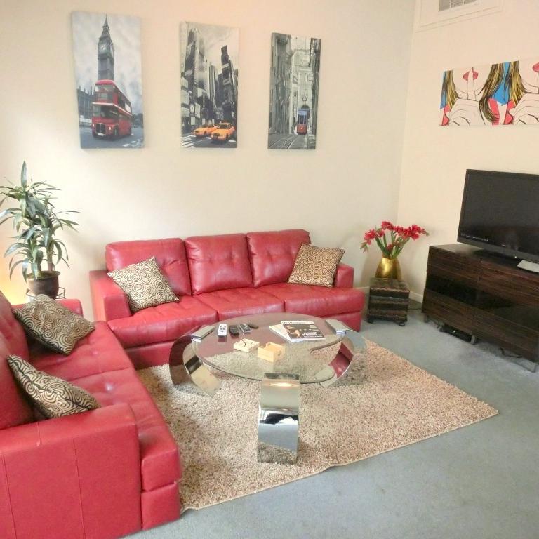 Broadway Suite: big airy living room with balcony and decorative fireplace,  two well-sized bedrooms, bathroom with over tube shower and well-equipped kitchen