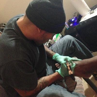 StilloThaGod's profile picture. Spanish nigga with the beard & tattoo gun