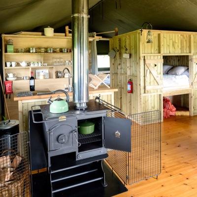 Glamping on a family farm in Cornwall overlooking St.Michaels Mount. Think chickens, calves, wellies, mud, rosy cheeks, campfire, marshmallows & beach days!