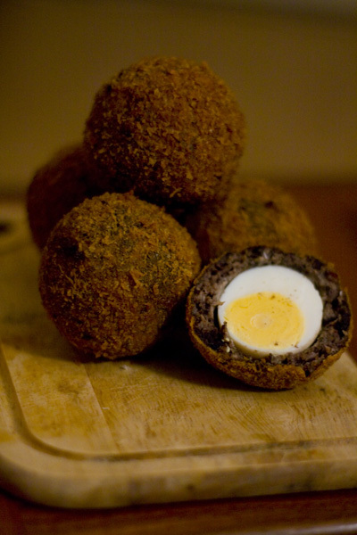 Hand producing the famous Manchester Egg. A pickled egg wrapped in black pudding and sauasage meat coated in a golden crumb. Everyone seems to like them.