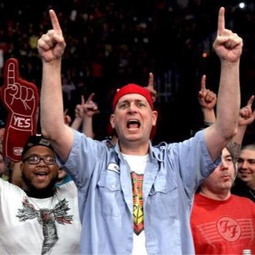 red hat, blue workman shirt. Holds up signs and acts like an idiot at professional wrestling events.