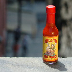 Just a bottle of hot sauce, standing in front of some food, wanting to be used ... 'cause it's always better with hOtsAUcE!