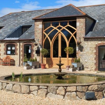 Holiday Cottages for the discerning set around an impeccably restored Dorset Tithe Barn in secluded grange gardens. Just minutes from the sea. Family friendly.