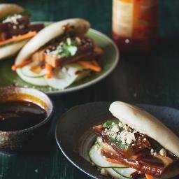 Authentic kick ass steamed Bao buns filled with veggie satay or spicy Asian style barbecued belly pork, with kimchi, cucumber salad & pickles