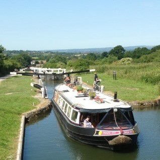 Widebeam hotel boat carrying guests through the waterways of England