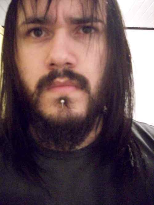 a tall man 1.90 115kg...long black hair full facial hair very tattooed