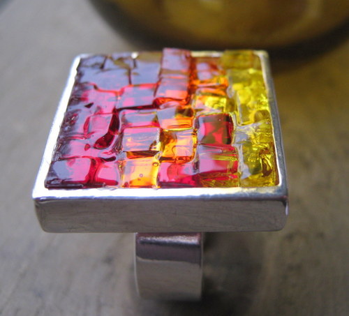 Mosaic Artist working with stained glass creating accessories.