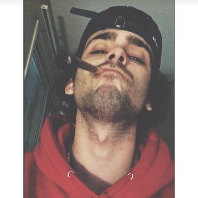 probably holding a beer and texting your bitch