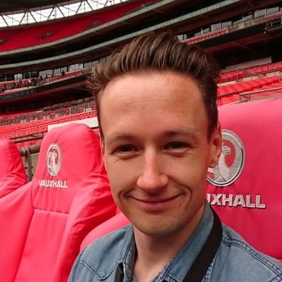 An average club runner running two laps of an athletics track working as a product manager