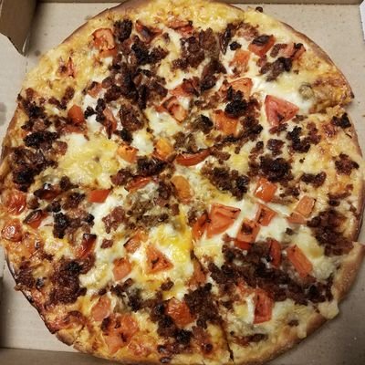 Buy the American Dream pizza on Nov. 16 next Thursday at Aurelio's Pizza! Toppings include bacon, tomatoes, and ground beef.