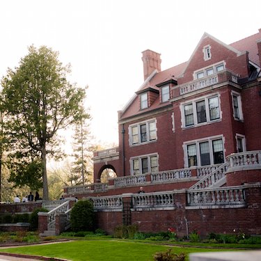 An estate featuring a fairytale stone arch bridge, breathtaking shoreline, set with a historic mansion and three-tier terrace backdrop. An award winning venue.