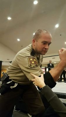 Pro wrestling cop who, when I am not busting perps, am busting heads in the square circle!