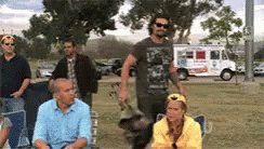 Gif: Jason Momoa opening a folding chair to sit down