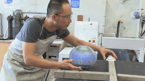 GIF of a man making a glass and porcelain piece.