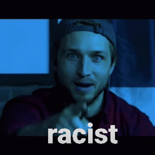 a white man points at the viewer, saying "racist"