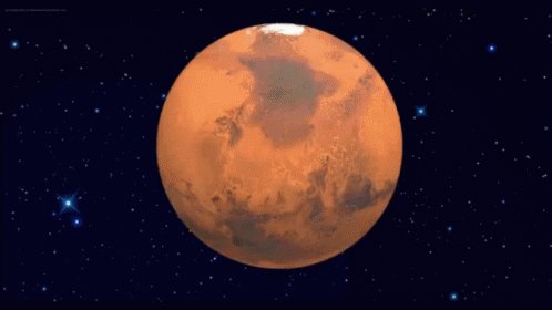 Mars spinning against the blackness of space. The white ice 