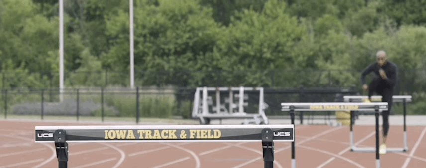 Gif showing a runner jumping over hurdles.