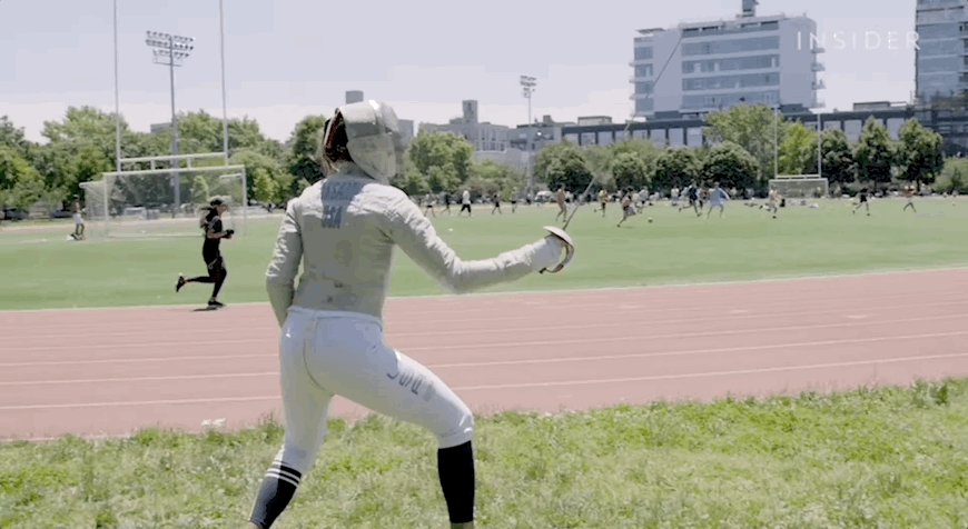 Gif showing a woman practicing fencing.