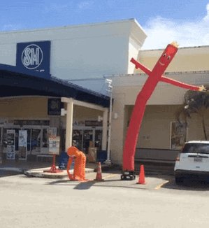 Two waving tube men, one large and one very small. The small