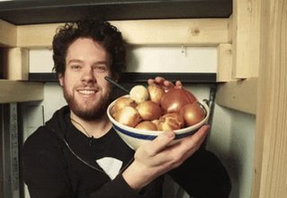 A guy with a bowl of onions...