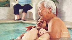 Nick Miller in a pool with ...